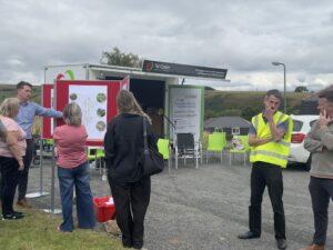 a group of people looking at plans for the new housing site