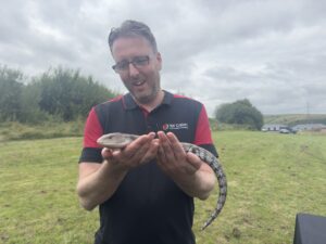 Tai Calon employee holding a lizard