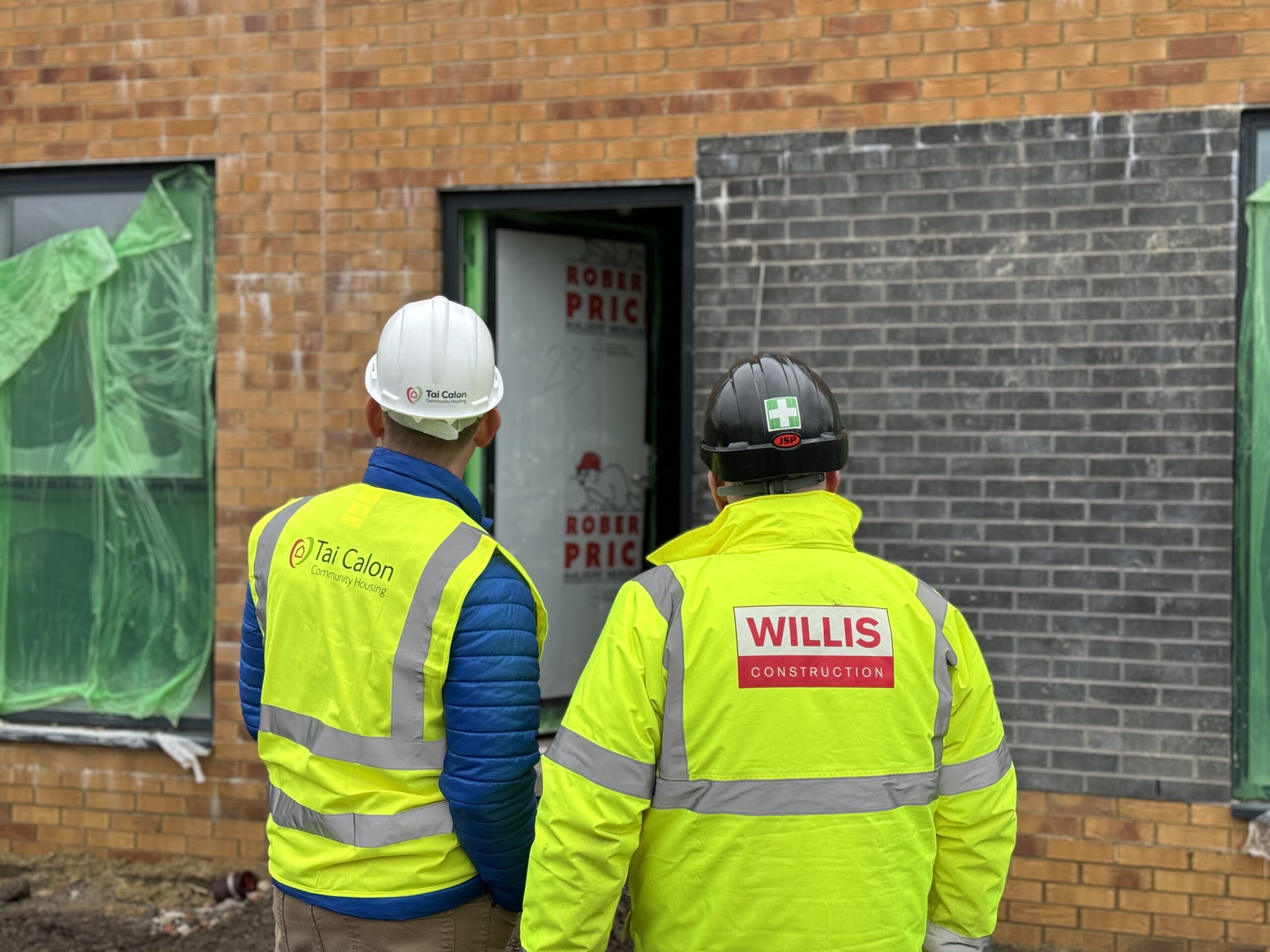 Tai Calon worker and Willis Construction worker admiring the new build home.
